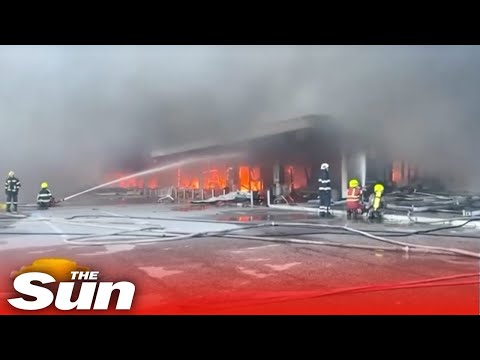 Firefighters tackle HUGE blaze at bombed shopping mall - at least 10 killed